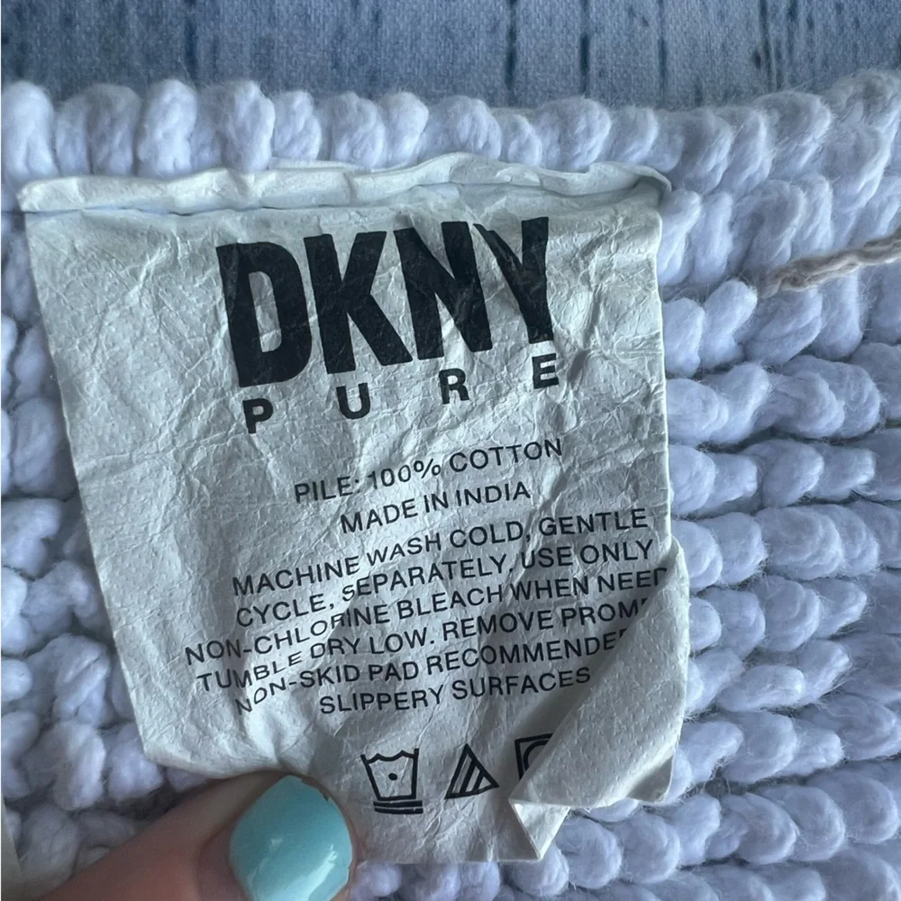 DKNY white bathroom rug 33in x 19in EUC